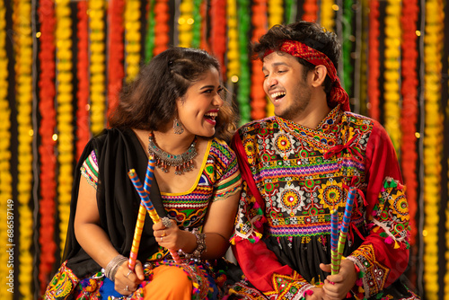Portrait of a young Gujarati couple dressed in a traditional Gujrati attire, during Navratri festival