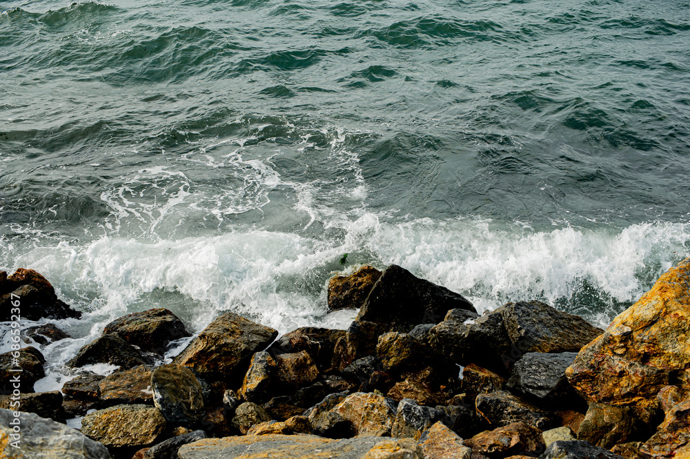 sea waves crashing on rocks
