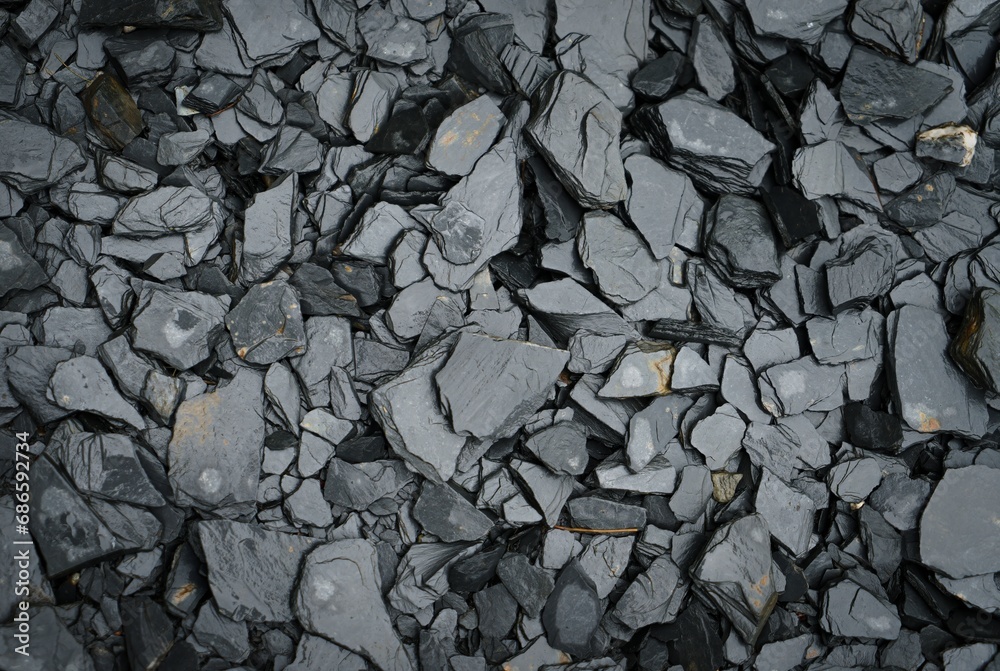 Set of black textured and water-wet rocks on a beach. Set of black textured and water-wet rocks on a beach.