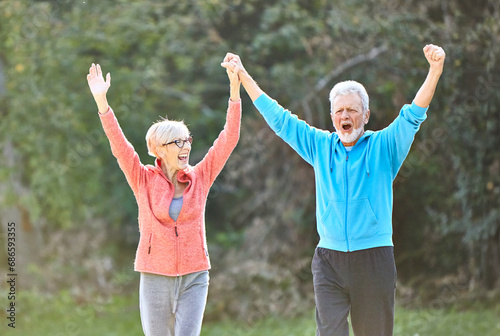 senior fitness woman man active sport exercise together running jogging hand celebrate celebration happy raised arm success victory team achievement teamwork winner up winning freedom healthy fit © Lumos sp