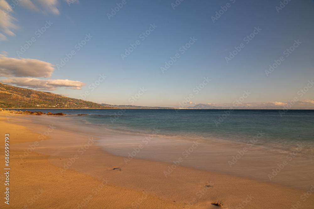 Sandy Beach with Clear Blue Water and Mountain View