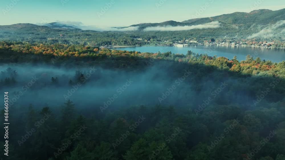 Autumn foliage aerial view in Lake George with morning fog