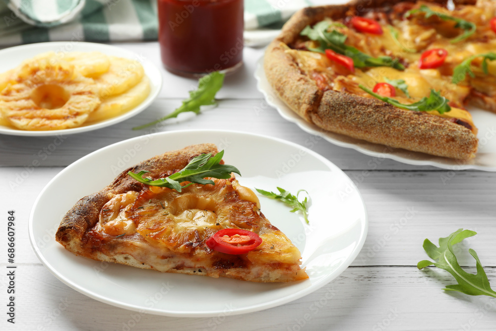 Plate with piece of delicious pineapple pizza on white wooden table Plate with piece of delicious pineapple pizza on white wooden table