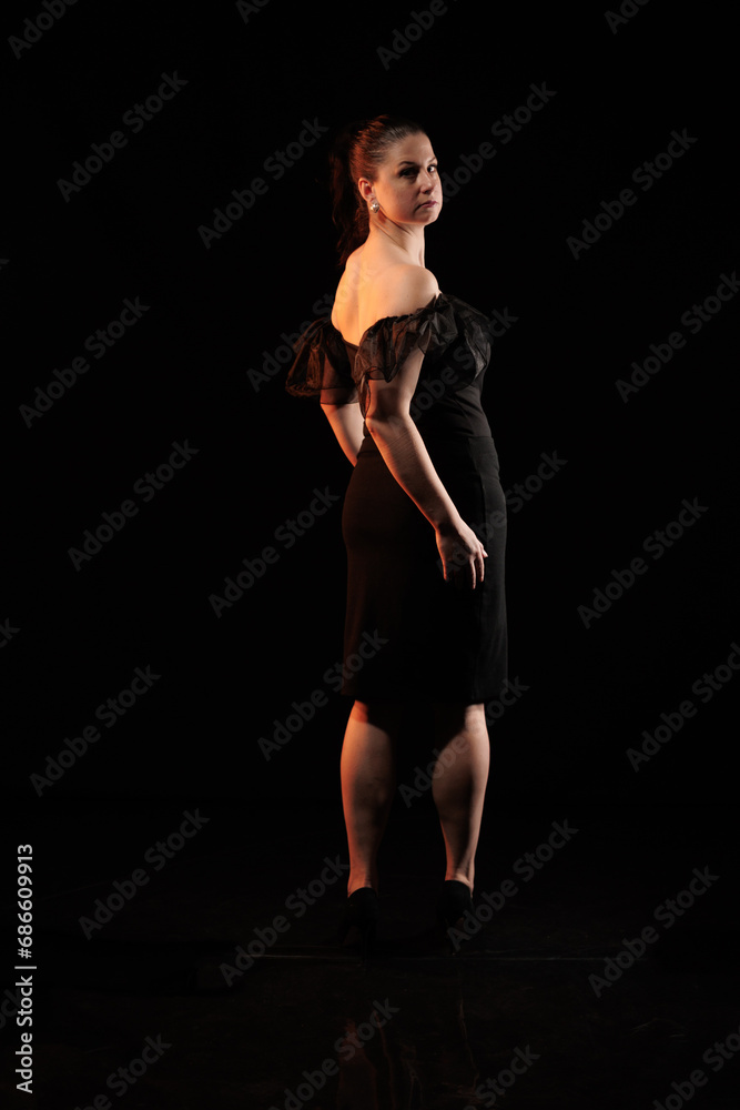 Obraz premium brunette woman posing in black studio