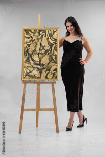 female artist paints a picture in the studio photo