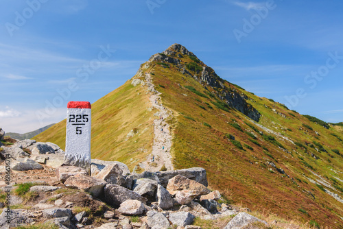 Polish Tatra Mountains, high mountain hiking trail leading to mountain peaks, mountain landscape with valleys and slopes, view on a sunny summer day.View of the Kondracka Kopa mountain peak.