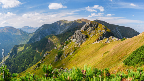 Fototapeta Naklejka Na Ścianę i Meble -  Polish Tatra Mountains, high mountain hiking trail leading to mountain peaks, mountain landscape with valleys and slopes, view on a sunny summer day.