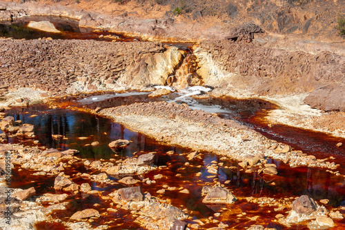 Section of the Rio Tinto running through rocky terrain in Huelva (Spain). The intense red colour is due to the weathering of the minerals present in its waters photo