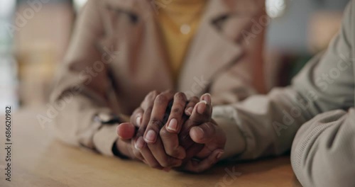 Holding hands, comfort and couple at table for love, trust and care together after cancer diagnosis. Closeup, man support woman and empathy, help in crisis and kindness, connection and hope for faith photo