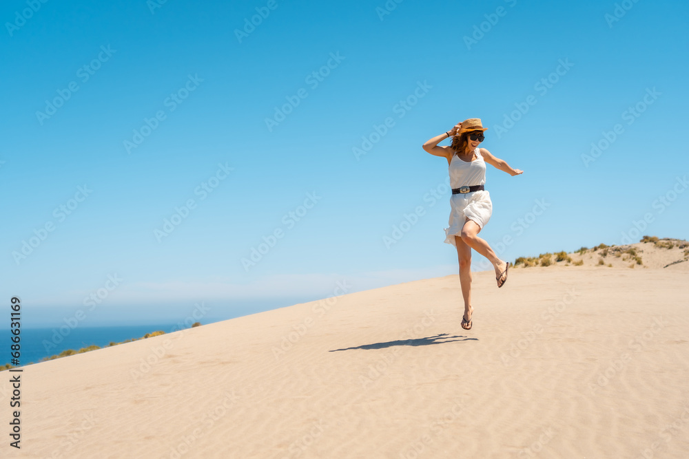 Happy woman jumping in a sea view point