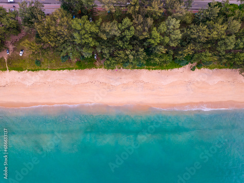 Bird eye view seashore with wave crashing on sandy shore. Beautiful waves sea surface in sunny day summer background, Amazing seascape top view seacoast landscape view