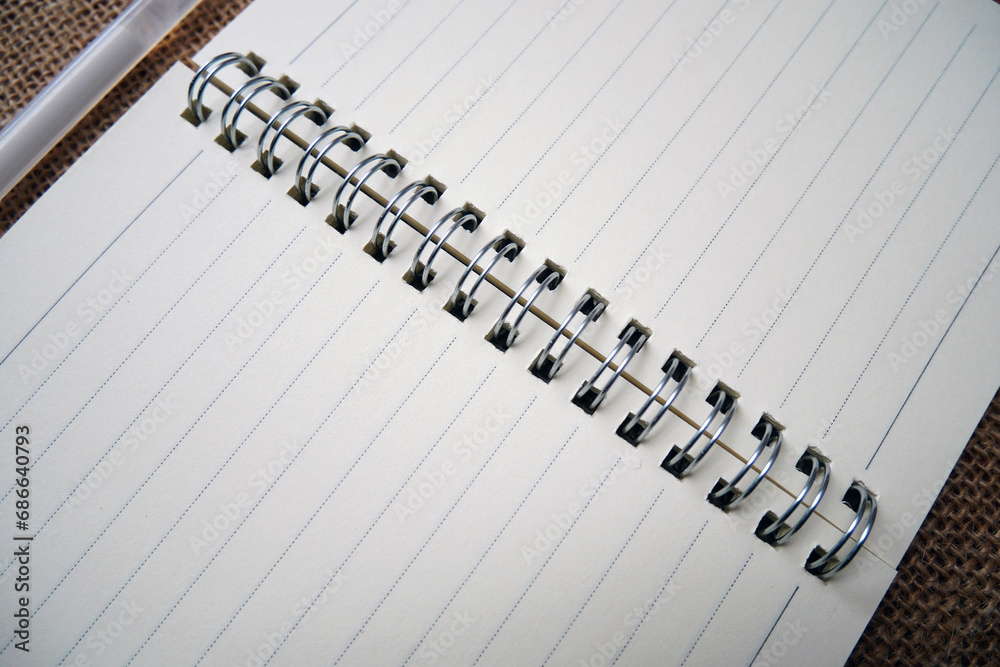 School notebook and white pen on burlap background with copy space School notebook and white pen on burlap background with copy space