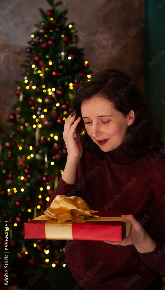 Young woman holding a box with a New Year gift.... Young woman holding a box with a New Year gift....