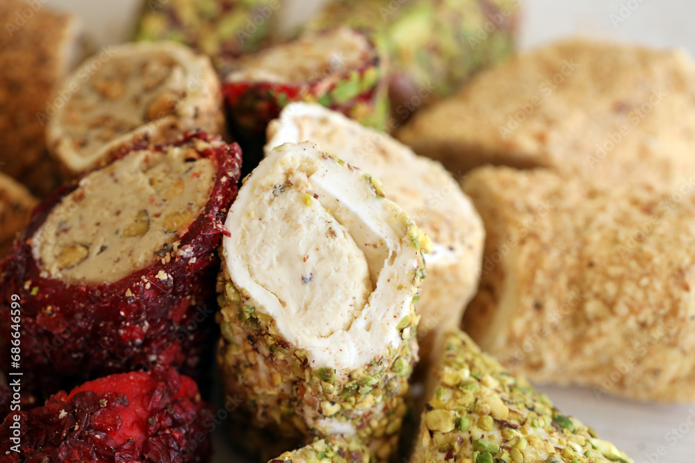 Many rolls of turkish delight with different flavors and fillings close up on table. Cutted Turk Lokumu bars Many rolls of turkish delight with different flavors and fillings close up on table. Cutted Turk Lokumu bars