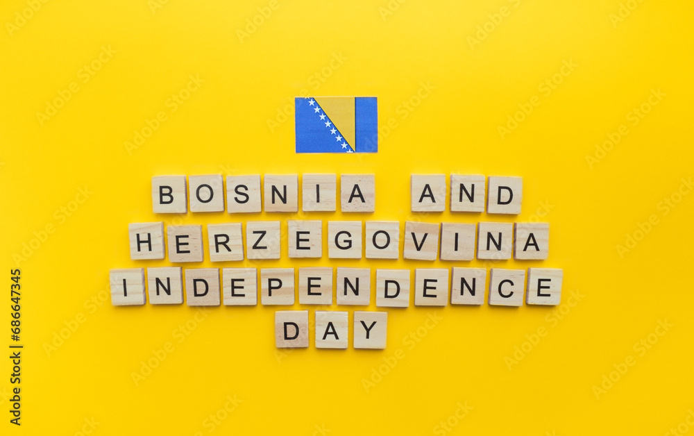 Obraz premium On March 1, Independence Day of Bosnia and Herzegovina, a minimalistic banner with an inscription in wooden letters on an orange background