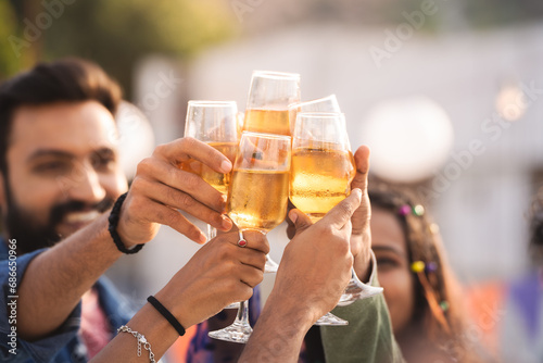 Close up shot, hands cheers or champagne glasses with drinks at successful celebration party or treat - concept of 2024 new year celebration, friends gathering and reunion