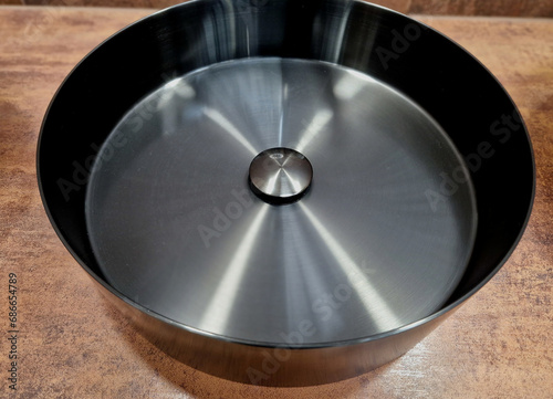 titanium color basin polished in a circle shape. luxury bathroom with brown tiles. counter, asian, wok, gray