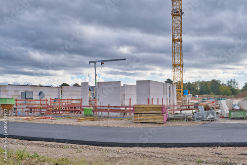 Construction site with high construction crane for building houses