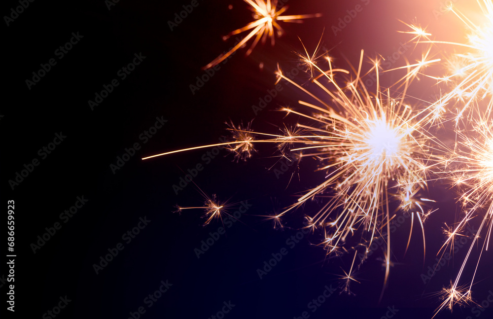 sparkling from fireworks. Background for New Year's celebrations, banner design. on the dark blue night sky