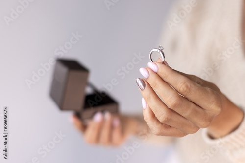 Special Moment: Woman Excitedly Holds a Gift Box and Engagement Ring