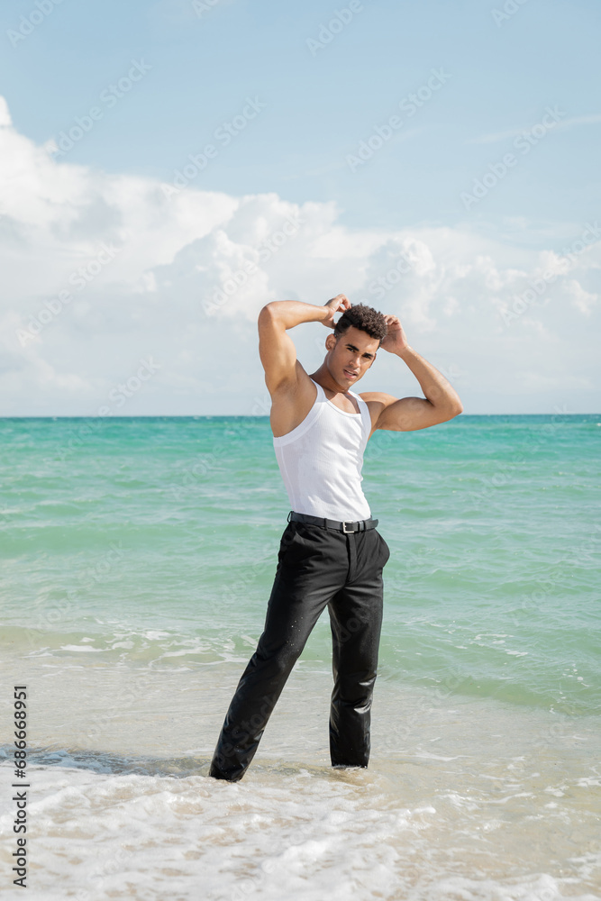 muscular young Cuban man standing in ocean water in Miami South Beach, Florida muscular young Cuban man standing in ocean water in Miami South Beach, Florida