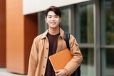 Asian young college student boy with schoolbag holding