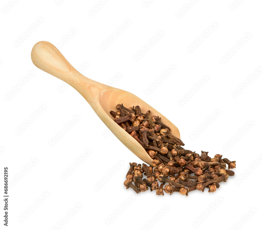 Dried cloves in the wooden spoon isolated on white background Dried cloves in the wooden spoon isolated on white background