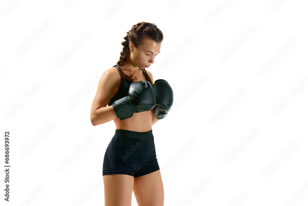 Portrait of strong and athletic woman, professional boxer, sportsman dressed in shorts and gloves posing against white studio background. Portrait of strong and athletic woman, professional boxer, sportsman dressed in shorts and gloves posing against white studio background.