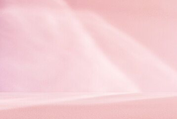 Empty pink colour room studio with sunlight effect shadow on the floor and wall for product presentation. Minimal backdrop design. Cosmetic, beauty and fashion showroom. Summer background mock up.