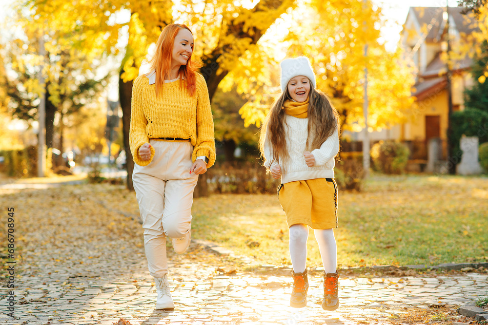 Lovely girl with her mom having fun on the walk. Autumn holidays, lifestyle. Lovely girl with her mom having fun on the walk. Autumn holidays, lifestyle.