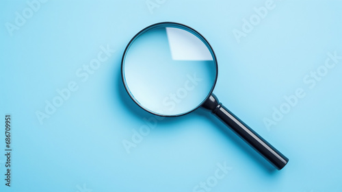 Top view empty lens black magnifying glass on white blue pastel background. Flat lay object and inspection investigate science equipment tool concept. Police and Ciencia forense theme. Copy space.