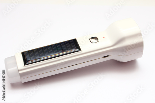 Close-up view of a solar cell flashlight on a white background. photo