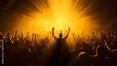 Concert crowd shadows against vibrant yellow stage lights. silhouette concept.