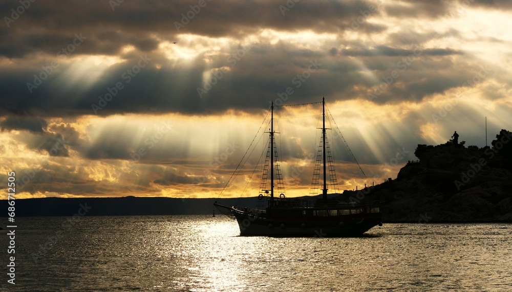 Big boat in beautiful sunset with rays of light