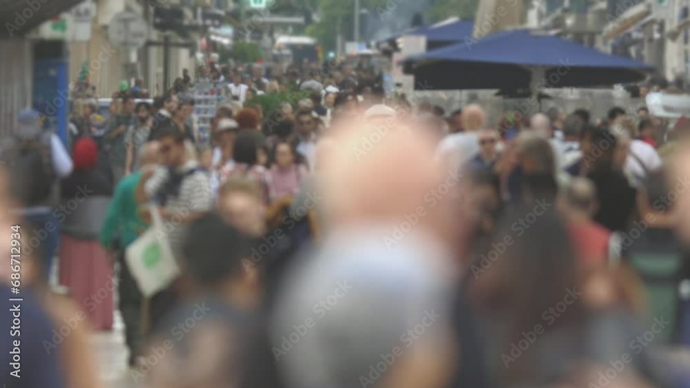 A Blurry Crowd of People Walking Down a Street A Blurry Crowd of People Walking Down a Street