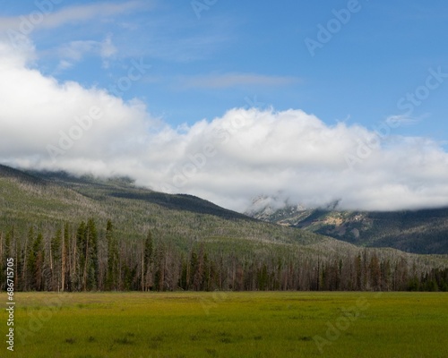Scenic view of a green landscape of mountains on a cloudy day