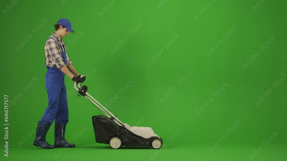 portrait-of-male-in-overalls-and-rubber-boots-on-chroma-key-green