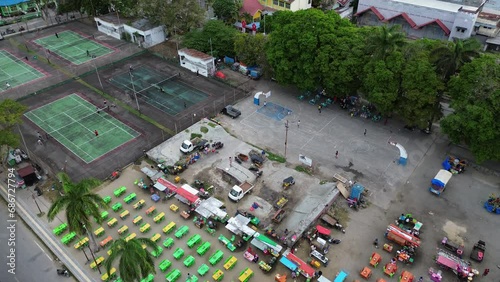 Aerial view of amusement park and local market in Gorontalo city. People relaxing, exercising, colorful plastic chairs in Gorontalo city, Indonesia. Retail shop photo