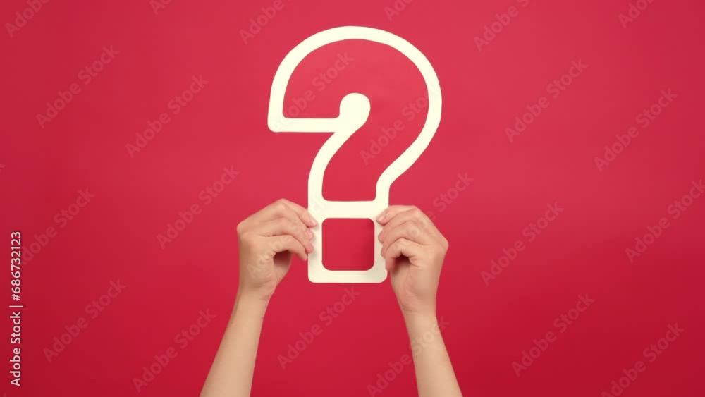 Close up of female hands holding big question mark sign, posing isolated over red color background in studio with copy space for promotion content. Business, plans, thoughts and advertisement concept Close up of female hands holding big question mark sign, posing isolated over red color background in studio with copy space for promotion content. Business, plans, thoughts and advertisement concept