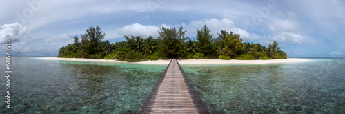 Small Tropical Island Panorama with Wooden Pier or Jetty leading to the tropical Paradise Beach - Republic of Maldives, Indian Ocean
