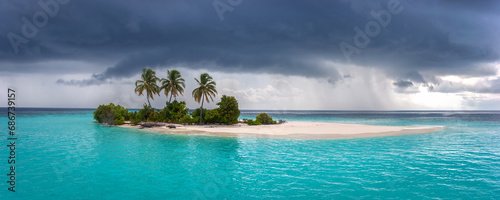 Idyllic Tropical Small Desert Island in Maldivian Paradise in Monsoon Rains Season at Risk for Sea level Rising due to Global Warming 