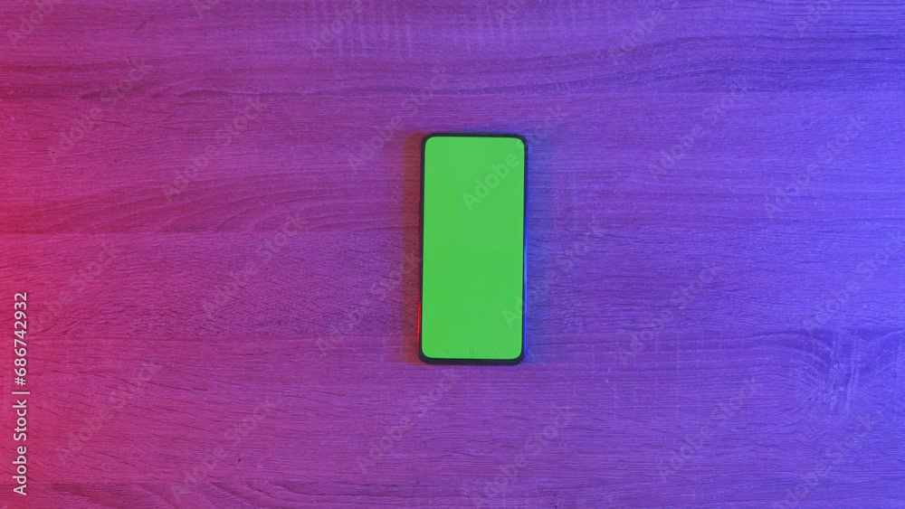 Top Down View Of A Smartphone With Mock Up Green Screen Chromakey Display On An Neon Desk. Online Gaming Concept, Zoom Out
Top Down View Of A Smartphone With Mock Up Green Screen Chromakey Display On An Neon Desk. Online Gaming Concept, Zoom Out