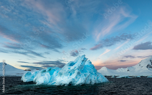 Iceberg and sunrise sky at 4:30 in the morning in the antarctic summer; Neumayer Channel, Antarctica photo