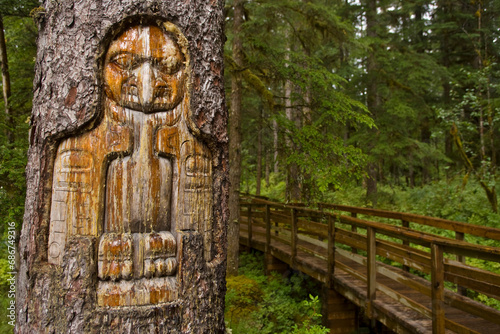 Tree trunk carved by a Native American artist at Bartlett Cove in Glacier Bay National Park; Alaska, United States of America photo
