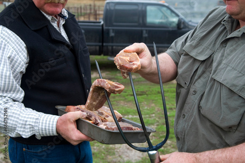 Steaks cooked on pitchforks at a ranch; Burwell, Nebraska, United States of America photo