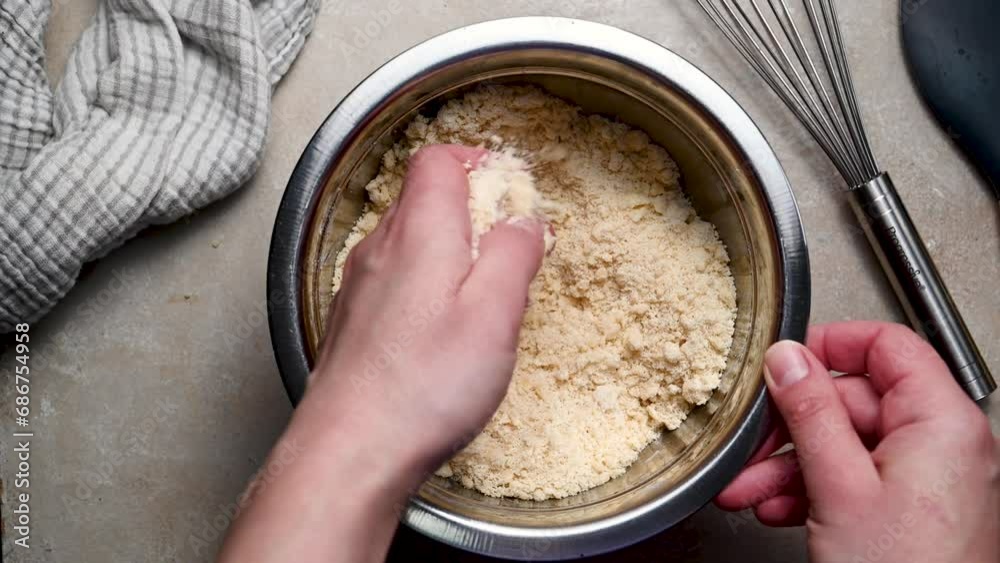 Kneading shortbread raw dough in bowl with hands. Baking at home concept. Kneading shortbread raw dough in bowl with hands. Baking at home concept.