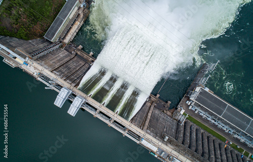 Aerial top down view of water discharge at hydroelectric power plant