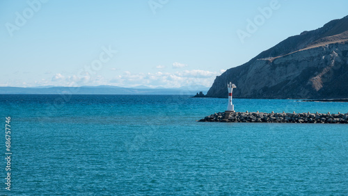 Seascape with a lighthouse on the Kuzu Limani harbour, on the island of Gokceada, Canakkale, Turkey. photo