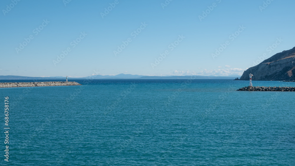 Seascape with a lighthouse on the Kuzu Limani harbour, on the island of Gokceada, Canakkale, Turkey.