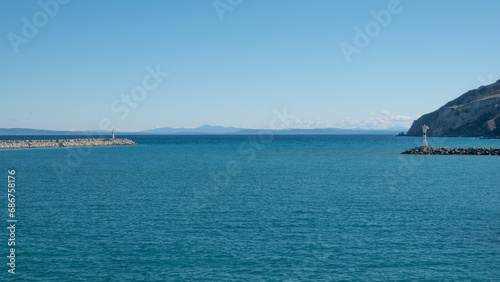 Seascape with a lighthouse on the Kuzu Limani harbour, on the island of Gokceada, Canakkale, Turkey. photo